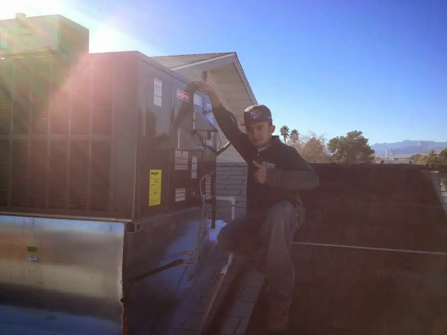HVAC technician performing AC Tune-Up on a rooftop unit in Upper Moreland